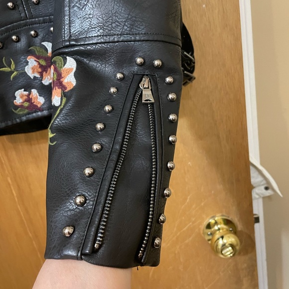 Floral embroidery, stud accents, buckles on side, faux leather, zipper on arms. - Picture 4 of 8